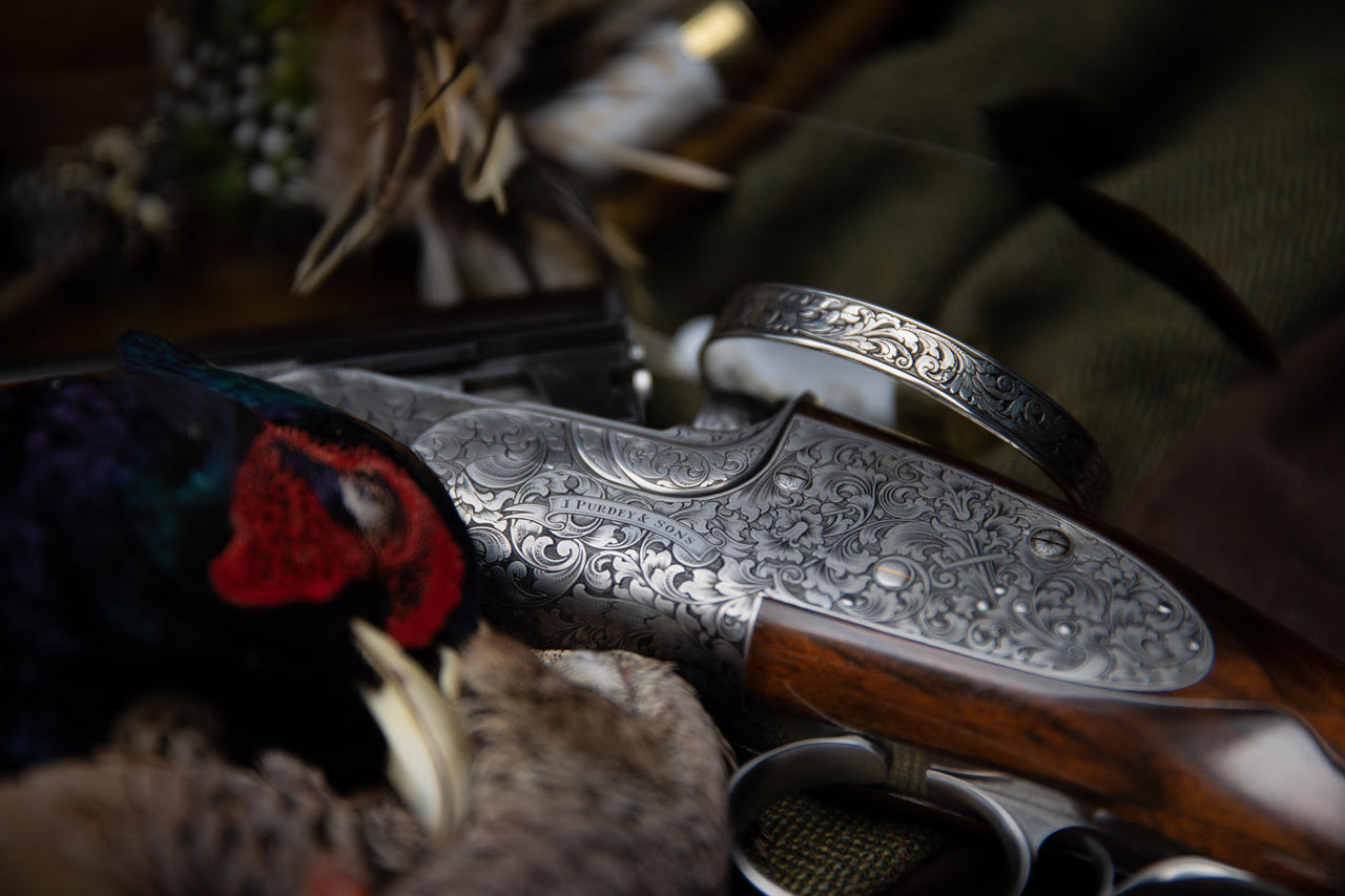 Purdey Shotgun with Ken Hunt Scroll Bracelet