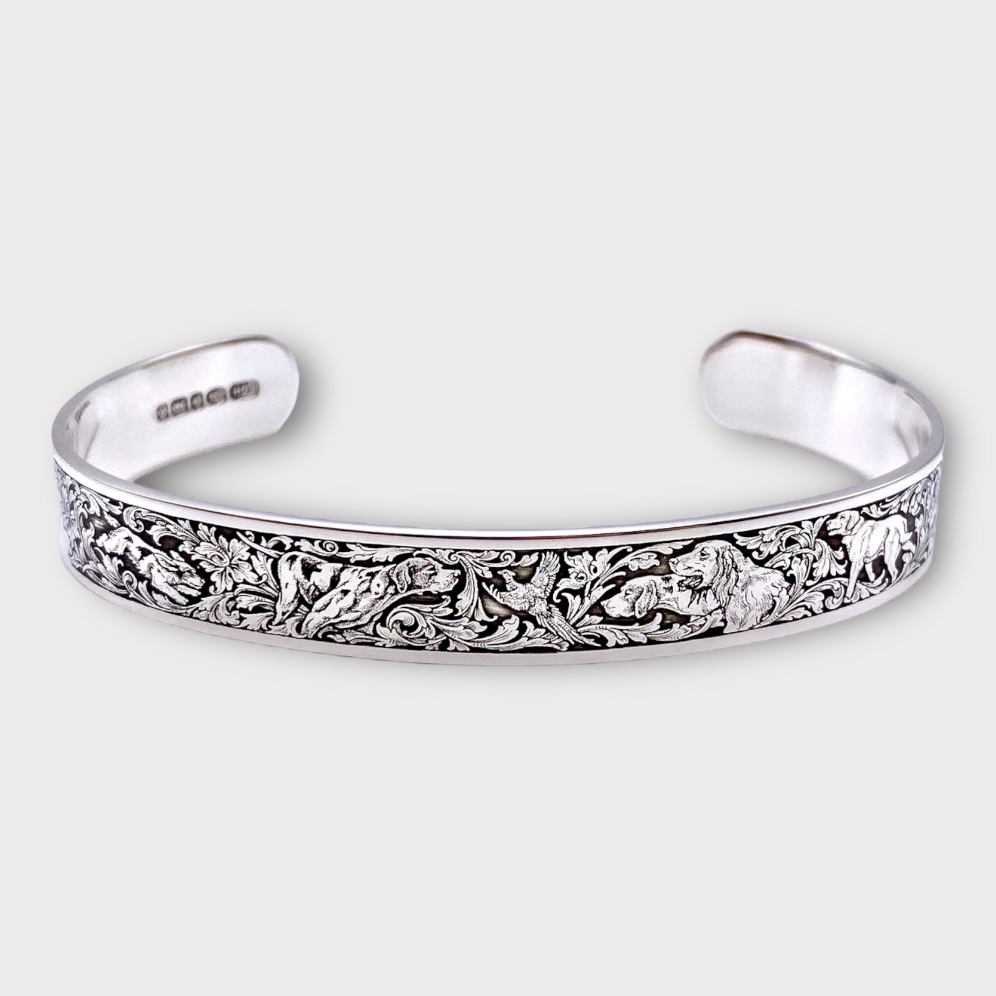 Engraved Ken Hunt sterling silver bracelet with gun engraving working dogs game scene engraving including spaniels, pointers, labradors and pheasants