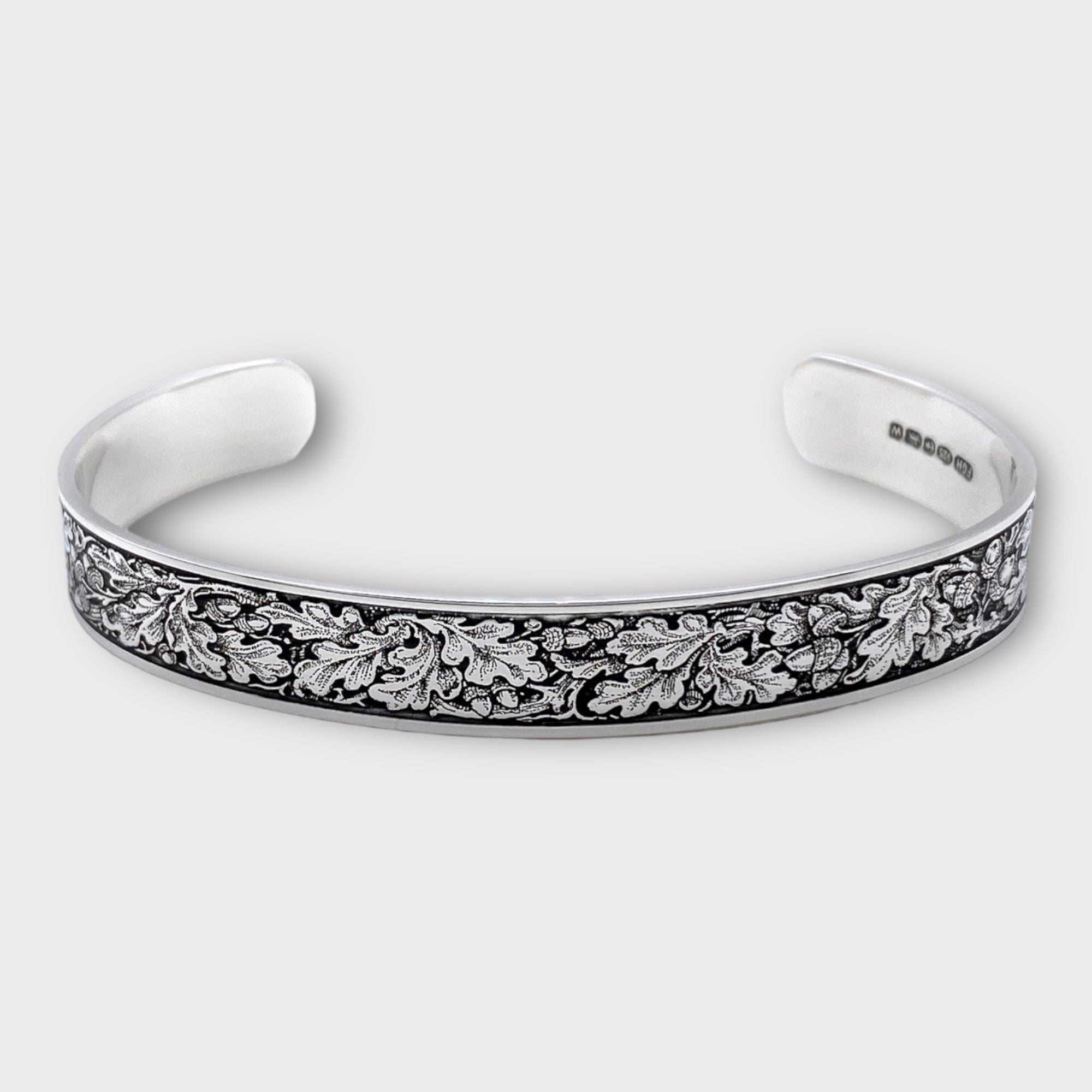 Engraved sterling silver bangle bracelet filled with oak leaves in gun engraving style from Ken Hunt. Perfect shooting gift. 