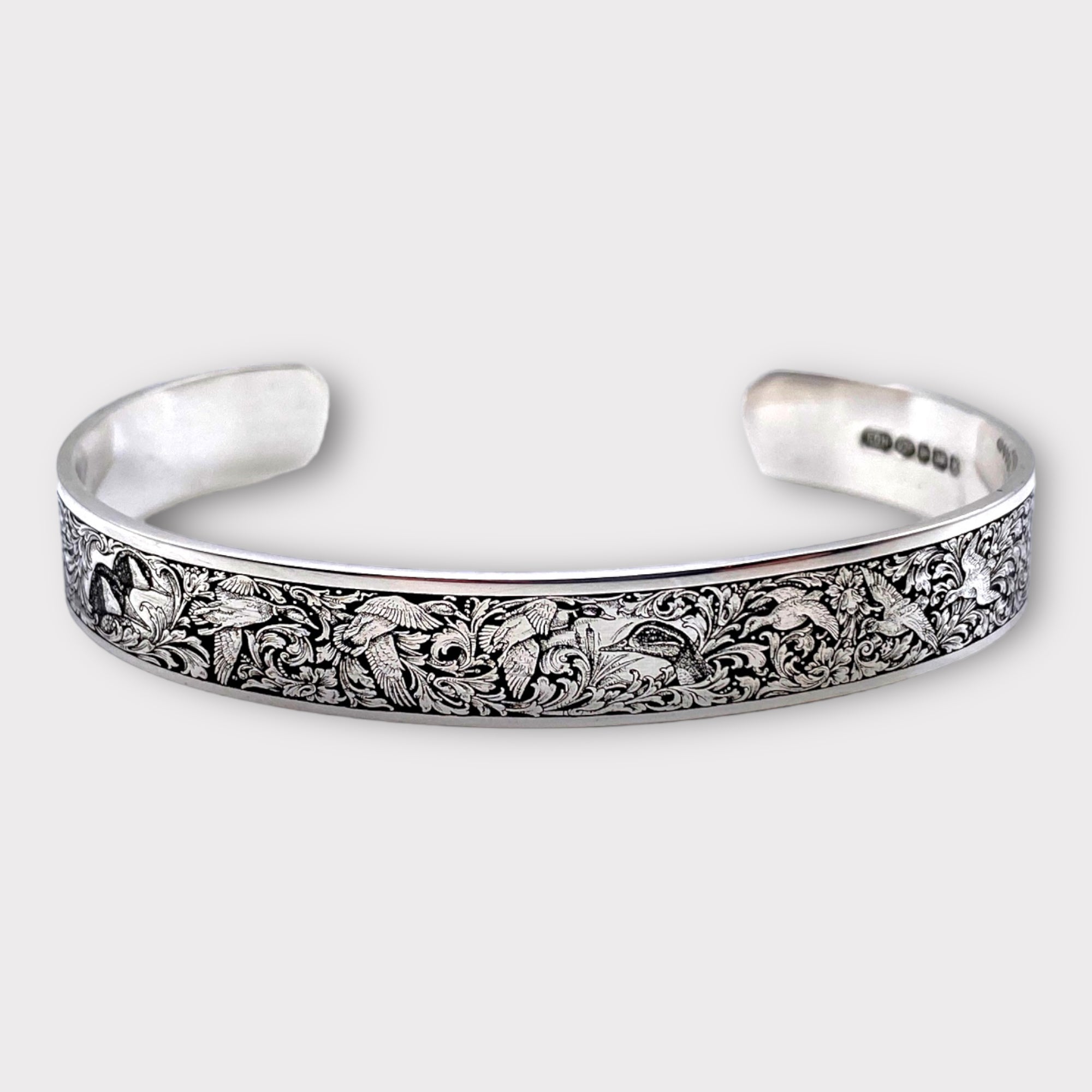 Engraved sterling silver bracelet with birds in flight game scene engraving